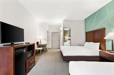 a hotel room with a bed and a flat screen tv at Comfort Inn Pocono Lakes Region in Lake Ariel