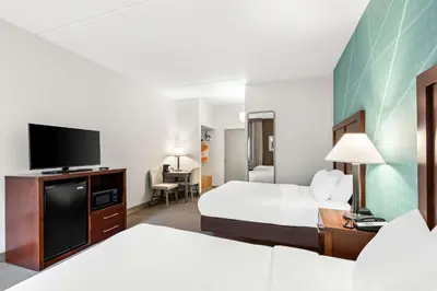 a hotel room with two beds and a flat screen tv at Comfort Inn Pocono Lakes Region in Lake Ariel