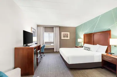 a hotel room with a bed and a flat screen tv at Comfort Inn Pocono Lakes Region in Lake Ariel