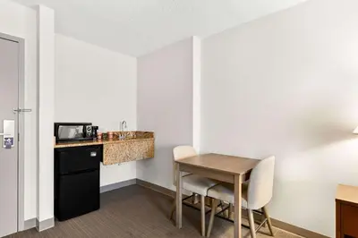 a small room with a table and a kitchen at Comfort Inn Pocono Lakes Region in Lake Ariel