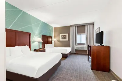 a hotel room with two beds and a flat screen tv at Comfort Inn Pocono Lakes Region in Lake Ariel