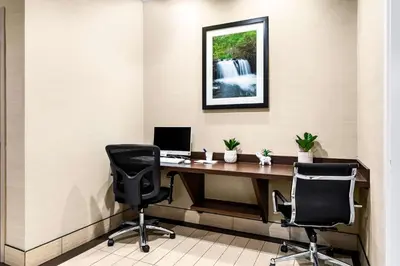an office with a desk with a computer and two chairs at SureStay Plus by Best Western Reading North in Reading