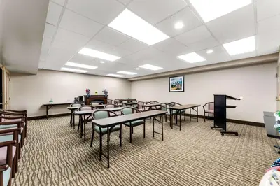 a classroom with tables and chairs in a room at SureStay Plus by Best Western Reading North in Reading