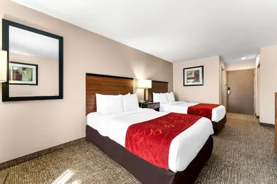a hotel room with two beds and a bathroom at SureStay Plus by Best Western Reading North in Reading