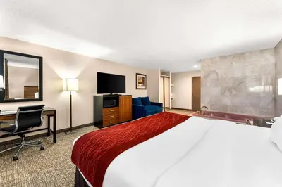 a hotel room with a large bed and a desk at SureStay Plus by Best Western Reading North in Reading