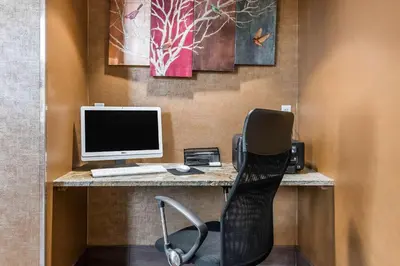 a desk with a computer and a chair in a room at Comfort Inn Pine Grove I-81 Hershey Area in Pine Grove