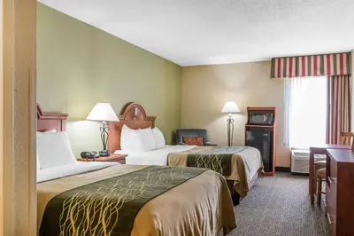 a hotel room with two beds and a desk at Comfort Inn Pine Grove I-81 Hershey Area in Pine Grove