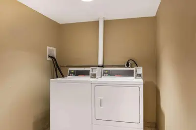 a washer and dryer in a corner of a room at Comfort Inn Pine Grove I-81 Hershey Area in Pine Grove