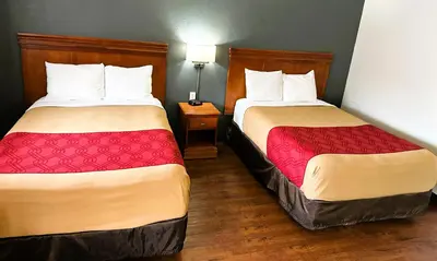 two beds in a hotel room next to each other at Econo Lodge Drums in Drums