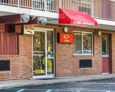 a restaurant with a red awning on a building at Econo Lodge Drums in Drums