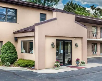 a large building with plants in front of it at Econo Lodge Douglassville-Pottstown in Douglassville