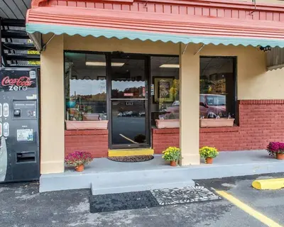 a store front with potted plants in front of it at Econo Lodge Frackville in Frackville
