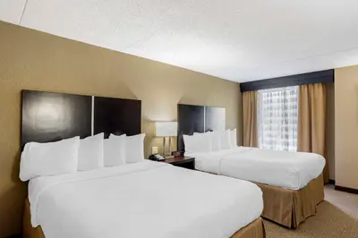 a hotel room with two beds and a window at Best Western Harrisburg North Hershey in Harrisburg
