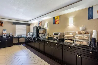 a restaurant with a counter with aasteryasteryasteryasteryasteryasteryasteryasteryastery at Best Western Harrisburg North Hershey in Harrisburg