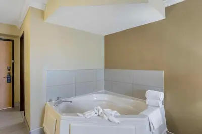 a white bath tub in a room with at Best Western Harrisburg North Hershey in Harrisburg