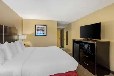 a hotel room with a large bed and a flat screen tv at Best Western Harrisburg North Hershey in Harrisburg