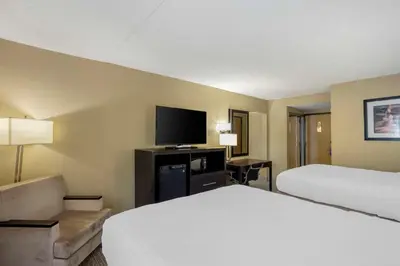 a hotel room with a bed and a flat screen tv at Best Western Harrisburg North Hershey in Harrisburg