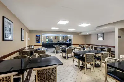 a dining room with tables and chairs in a restaurant at Best Western Harrisburg North Hershey in Harrisburg