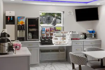 a kitchen with a counter with a refrigerator at Baymont by Wyndham Lancaster PA Dutch Country in Lancaster