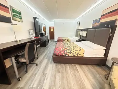 a bedroom with a bed and a desk and a computer at Baymont by Wyndham Lancaster PA Dutch Country in Lancaster