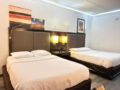a hotel room with two beds in a room at Baymont by Wyndham Lancaster PA Dutch Country in Lancaster