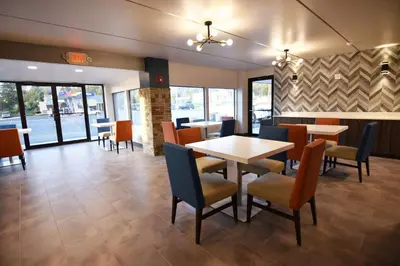 a dining room with tables and chairs in a restaurant at Baymont by Wyndham Pine Grove I-81 in Pine Grove