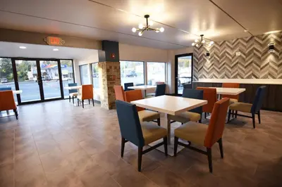 a dining room with tables and chairs in a restaurant at Baymont by Wyndham Pine Grove I-81 in Pine Grove