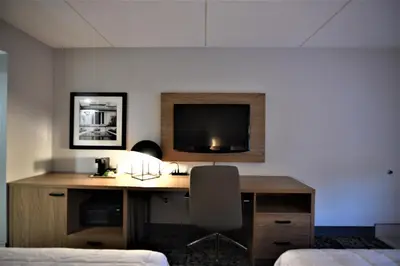 a room with a desk with a television on the wall at Baymont by Wyndham Pine Grove I-81 in Pine Grove