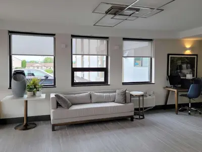 a living room with a couch and some windows at Comfort Inn & Suites Wyomissing-Reading in Wyomissing