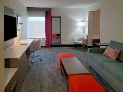 a hotel room with a couch and a living room at Comfort Inn & Suites Wyomissing-Reading in Wyomissing