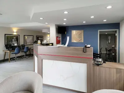 a hair salon with a reception counter and chairs at Comfort Inn & Suites Wyomissing-Reading in Wyomissing