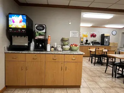 a waiting room with a counter with a tv on the wall at Quality Inn Wilkes-Barre near Arena in Wilkes-Barre