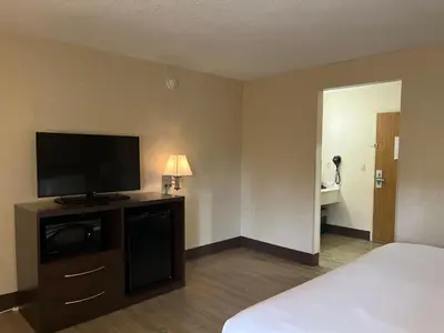 a hotel room with a bed and a flat screen tv at Quality Inn Wilkes-Barre near Arena in Wilkes-Barre