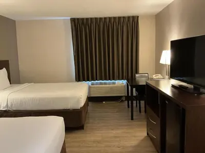 a hotel room with two beds and a flat screen tv at Quality Inn Wilkes-Barre near Arena in Wilkes-Barre