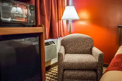 a room with a chair and a microwave at Econo Lodge Williamsport in Williamsport