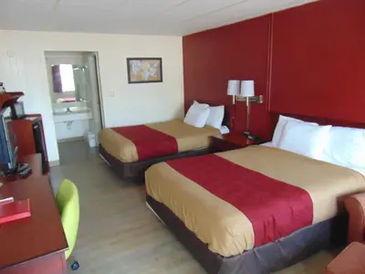 a hotel room with two beds and a desk at Econo Lodge Williamsport in Williamsport