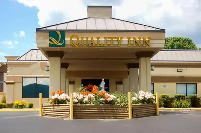 aania inc building with flowers in front of it at Quality Inn Mill Hall - Lamar in Clintondale