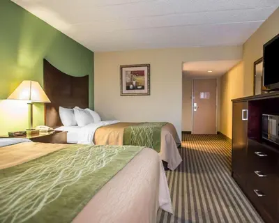a hotel room with two beds and a flat screen tv at Quality Inn Mill Hall - Lamar in Clintondale