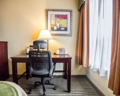 a hotel room with a desk and a chair at Quality Inn Mill Hall - Lamar in Clintondale