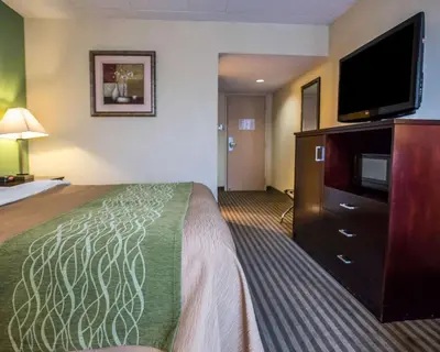 a hotel room with a bed and a flat screen tv at Quality Inn Mill Hall - Lamar in Clintondale