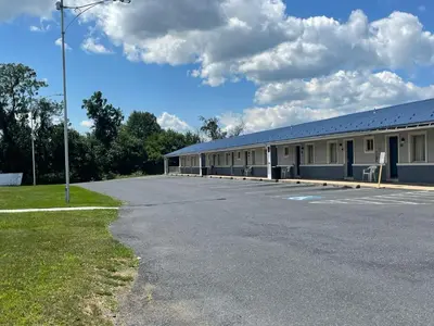 a building with a parking lot in front of it at Econo Lodge Mechanicsburg - Harrisburg West in Mechanicsburg