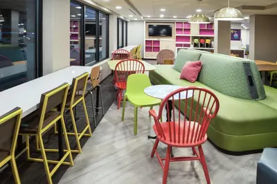 a living room with a green couch and chairs at Home2 Suites By Hilton King Of Prussia Valley Forge in King of Prussia