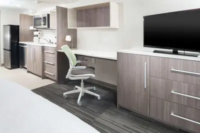 a hotel room with a desk with a tv and a chair at Home2 Suites By Hilton King Of Prussia Valley Forge in King of Prussia