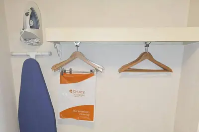 a room with two hangers and a sign on a wall at Quality Inn Selinsgrove in Selinsgrove