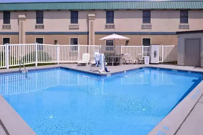 a large blue swimming pool in front of a building at Quality Inn Selinsgrove in Selinsgrove