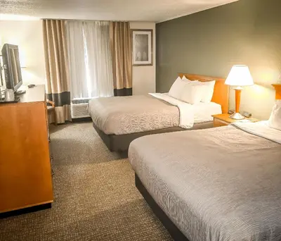 a hotel room with two beds and a television at Quality Inn Selinsgrove in Selinsgrove
