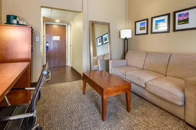 a living room with a couch and a table at Comfort Suites Bethlehem Near Lehigh University and LVI Airport in Bethlehem