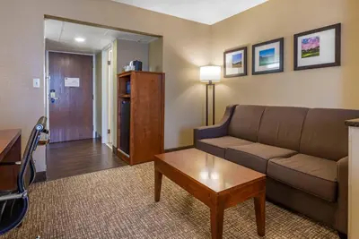 a living room with a couch and a table at Comfort Suites Bethlehem Near Lehigh University and LVI Airport in Bethlehem