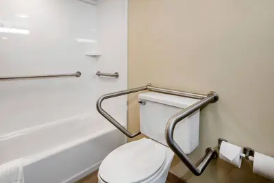 a bathroom with a toilet and a bath tub at Comfort Suites Bethlehem Near Lehigh University and LVI Airport in Bethlehem