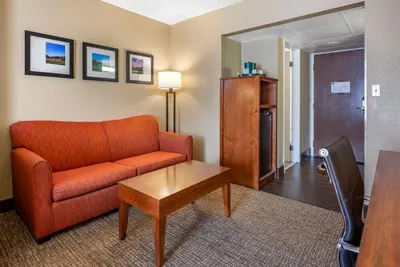 a living room with a couch and a table at Comfort Suites Bethlehem Near Lehigh University and LVI Airport in Bethlehem